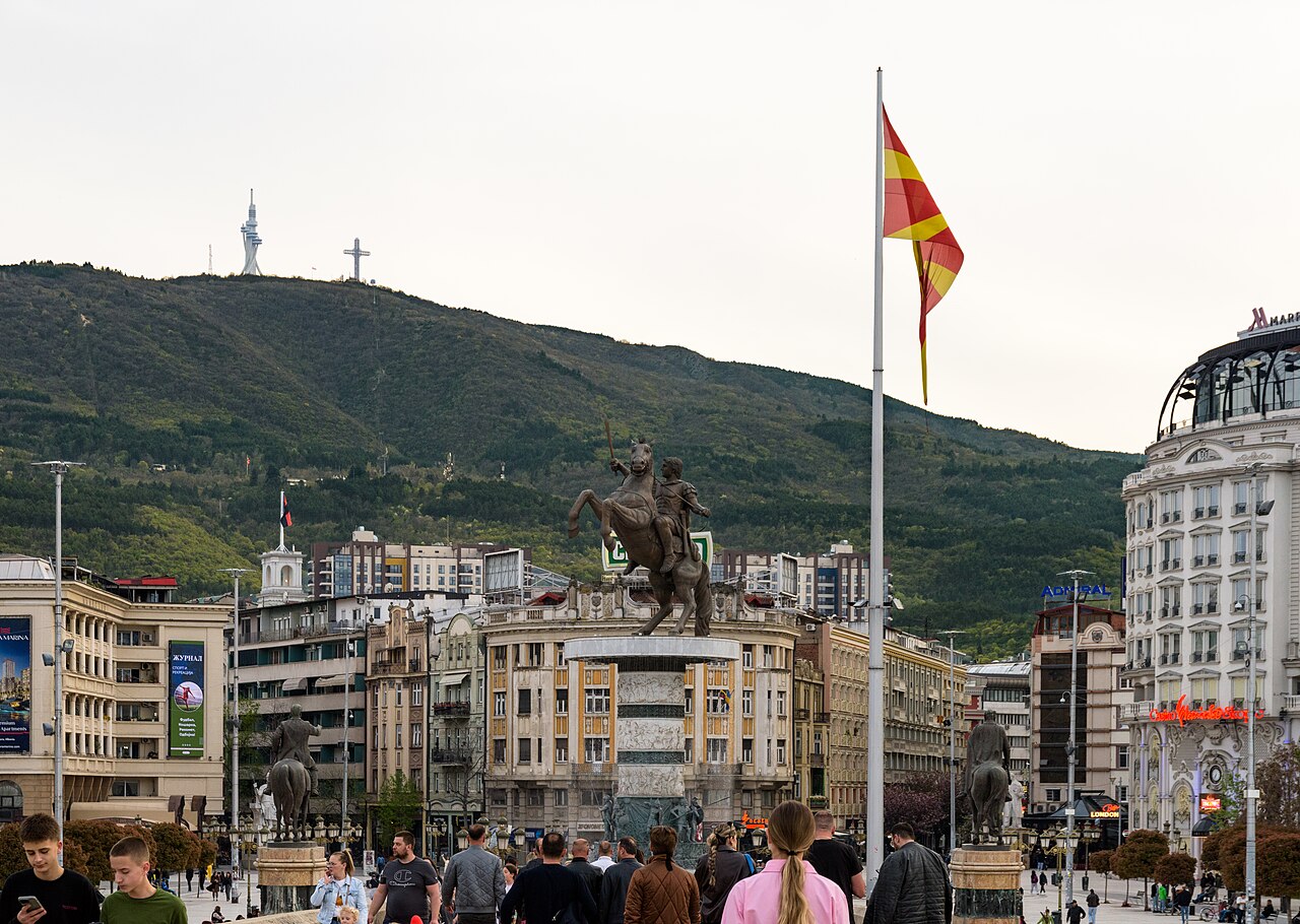 Macedonia Square in Skopje with the Warrior on a Horse statue and the Millennium Cross on Mount Vodno behind